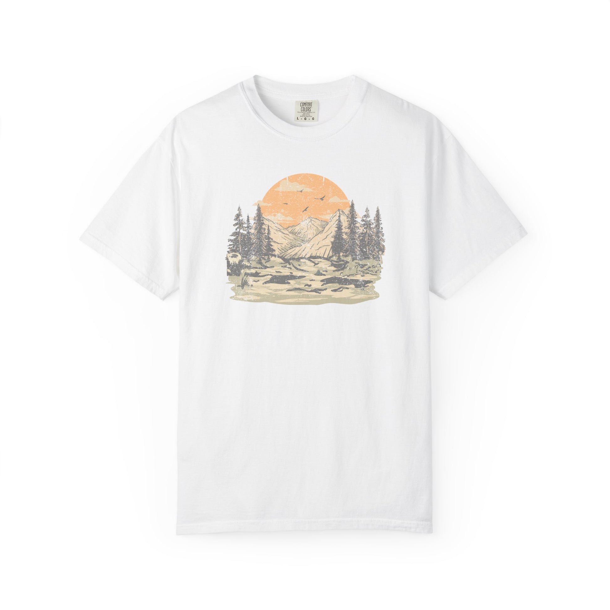 On the front of this custom comfort colors short sleeve t-shirt is a large vintage image of a large valley that opens up to a mountain range with pine trees , there is a large sun in the background with birds flying all around, this t-shirt is completely vintage.