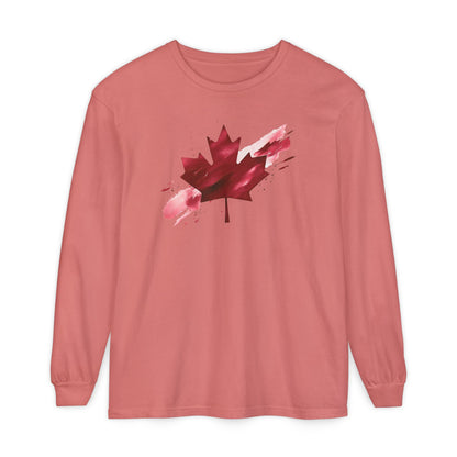 On the front of this unisex long sleeve shirt is an image of a Canadian maple leaf that is bright red, it looks like it has been spray painted onto the front of the shirt.