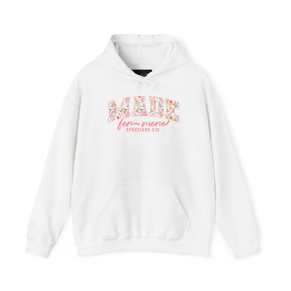 On the front of this custom Christian hoodie is the bible verse the says Made for more Ephesians 2:10, with the word "Made" being large block letters with a pink floral pattern inside the letters, all the other words are in a light pink color.