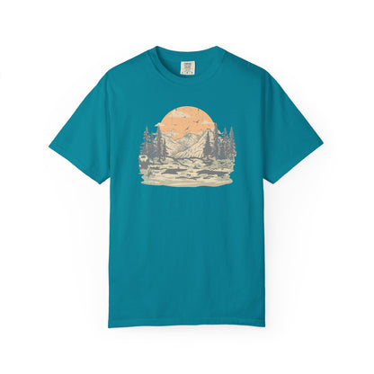 On the front of this custom comfort colors short sleeve t-shirt is a large vintage image of a large valley that opens up to a mountain range with pine trees , there is a large sun in the background with birds flying all around, this t-shirt is completely vintage.