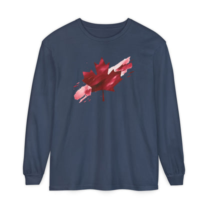 On the front of this unisex long sleeve shirt is an image of a Canadian maple leaf that is bright red, it looks like it has been spray painted onto the front of the shirt.