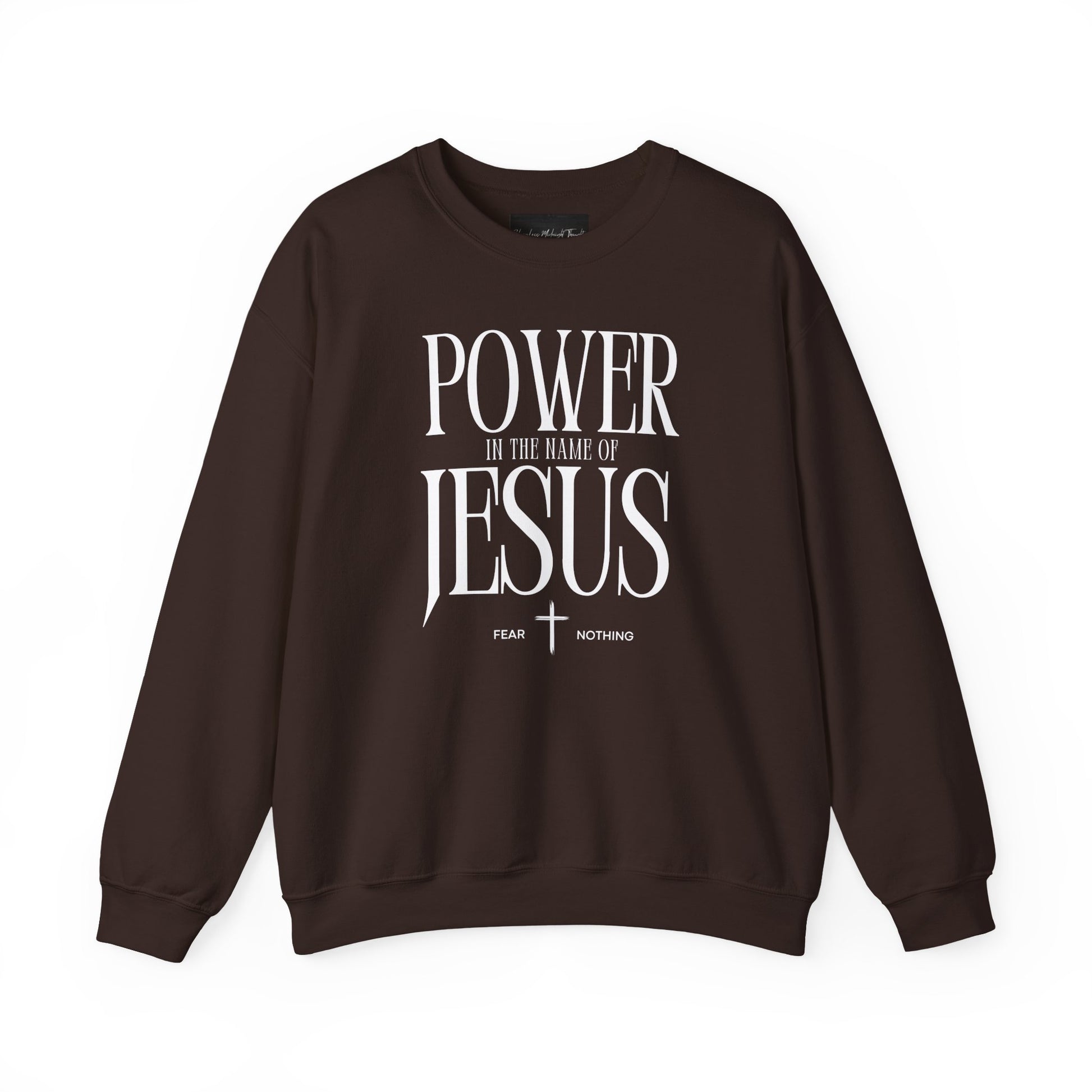 On the front of this Christian pullover sweatshirt it says Power In The Name Of Jesus with a Jesus cross underneath it, on either side of the cross are the words Fear and Nothing.