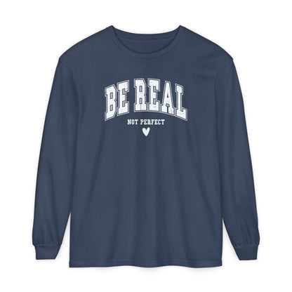 On the front of this custom unisex long sleeve shirt are the words Be Real in large bubble font with the words not perfect underneath the bubble letters, on the bottom there is a heart.