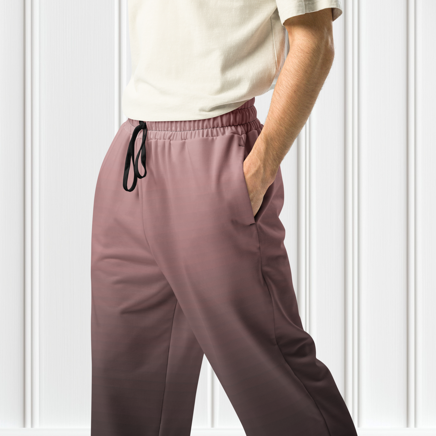 The super soft pair of wide leg unisex joggers that have a ombre pattern starting as a light mauve color on the top of the sweats and fading to a black color at the bottom of the sweats.