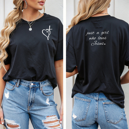 On the front of this custom women's Christian t-shirt is a heart with a cross through it, on the back top of the shirt right between the shoulder blades are the words just a girl who loves Jesus in a cursive writing.