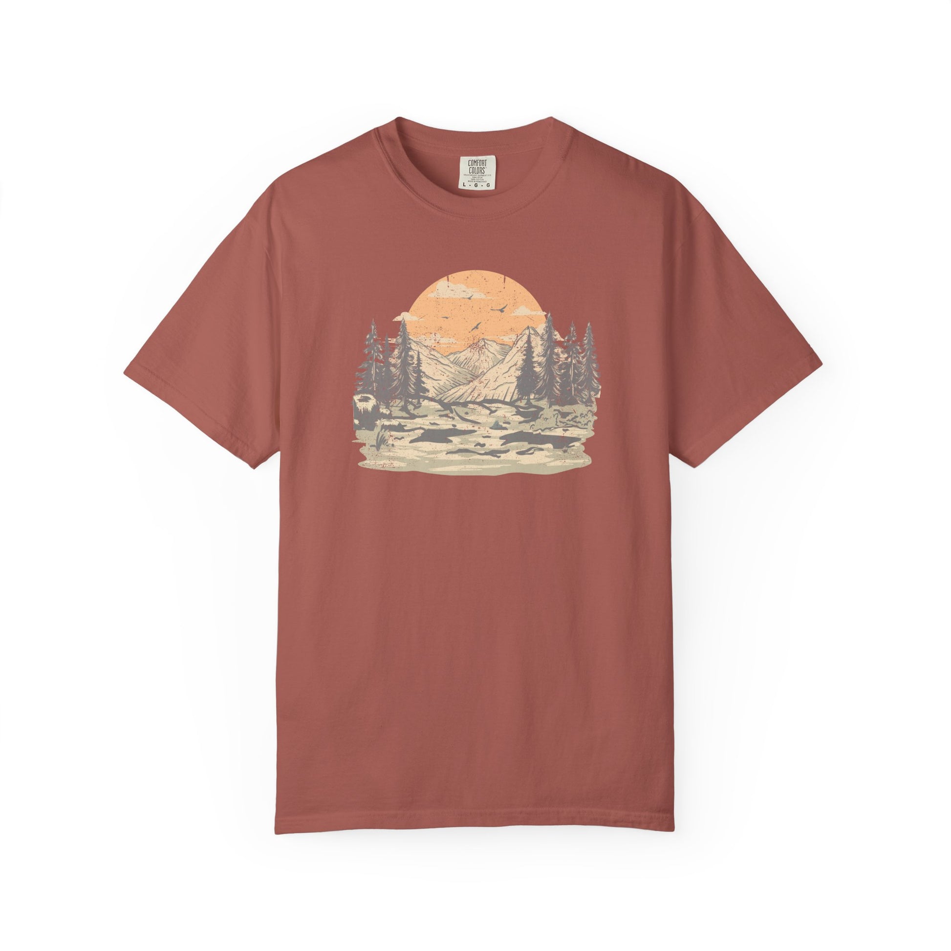 On the front of this custom comfort colors short sleeve t-shirt is a large vintage image of a large valley that opens up to a mountain range with pine trees , there is a large sun in the background with birds flying all around, this t-shirt is completely vintage.