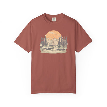 On the front of this custom comfort colors short sleeve t-shirt is a large vintage image of a large valley that opens up to a mountain range with pine trees , there is a large sun in the background with birds flying all around, this t-shirt is completely vintage.