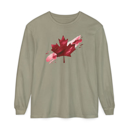 On the front of this unisex long sleeve shirt is an image of a Canadian maple leaf that is bright red, it looks like it has been spray painted onto the front of the shirt.