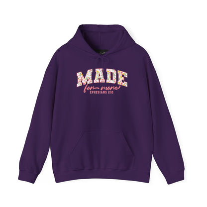 On the front of this custom Christian hoodie is the bible verse the says Made for more Ephesians 2:10, with the word "Made" being large block letters with a pink floral pattern inside the letters, all the other words are in a light pink color.