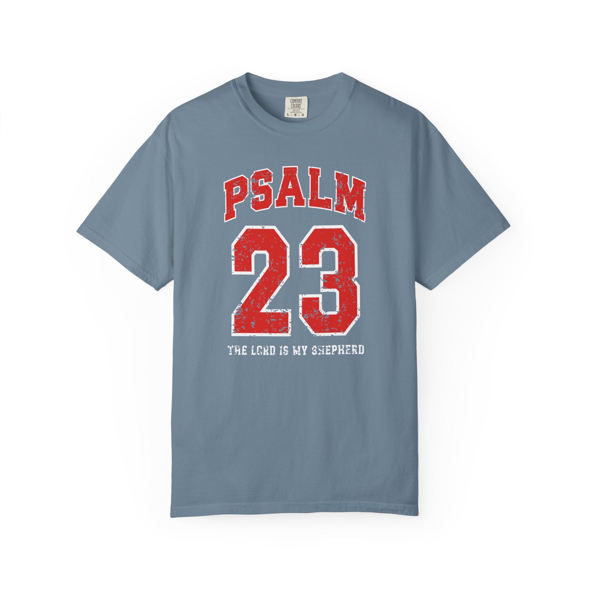 On the front side of this custom vintage t-shirt are the words Psalm 23 The Lord Is My Shepherd, it is with red and white block lettering.