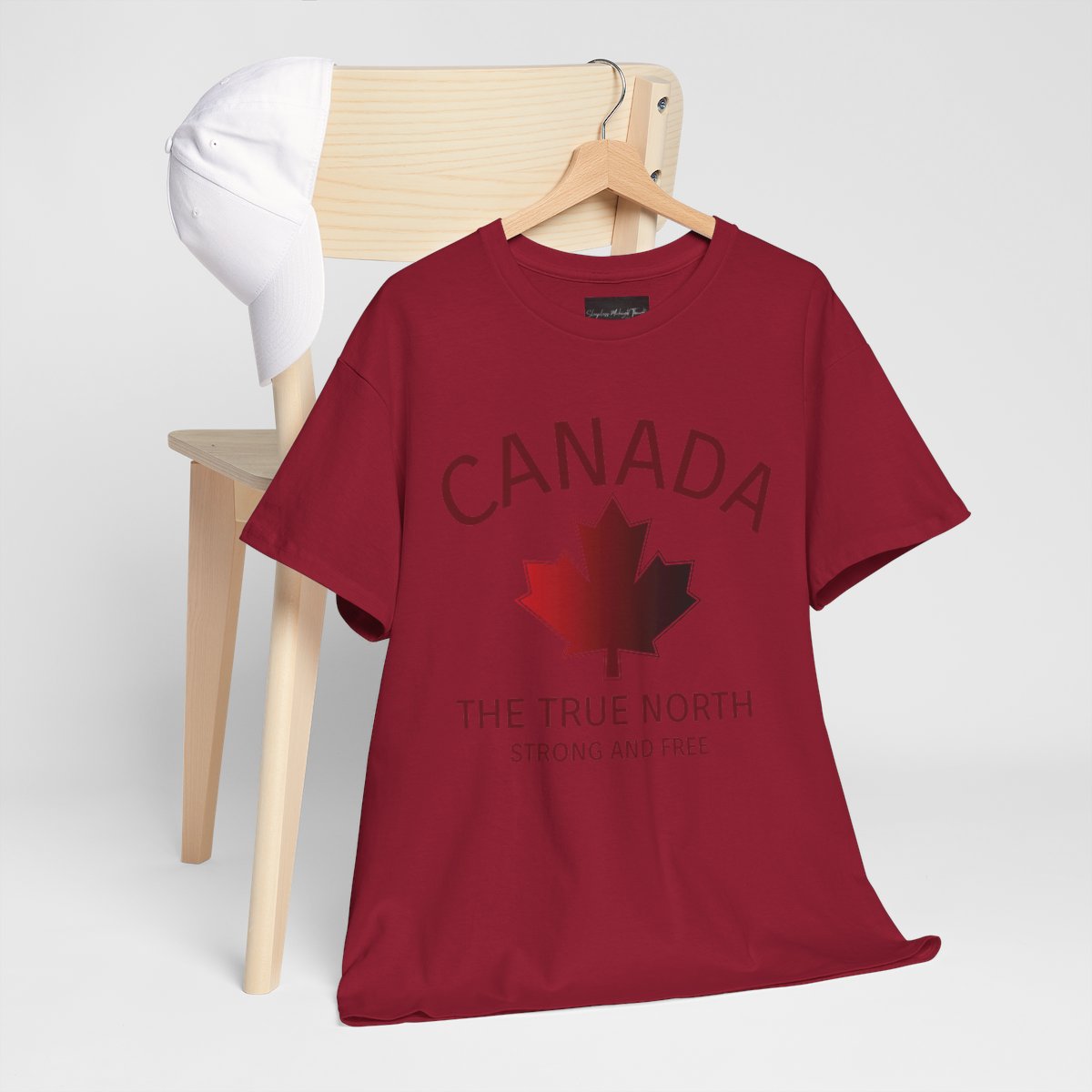 This custom Canadian made unisex custom t-shirt features the words Canada and The true North Strong And Free along with a maple leaf design in red, giving off a patriotic and Canadian vibe.