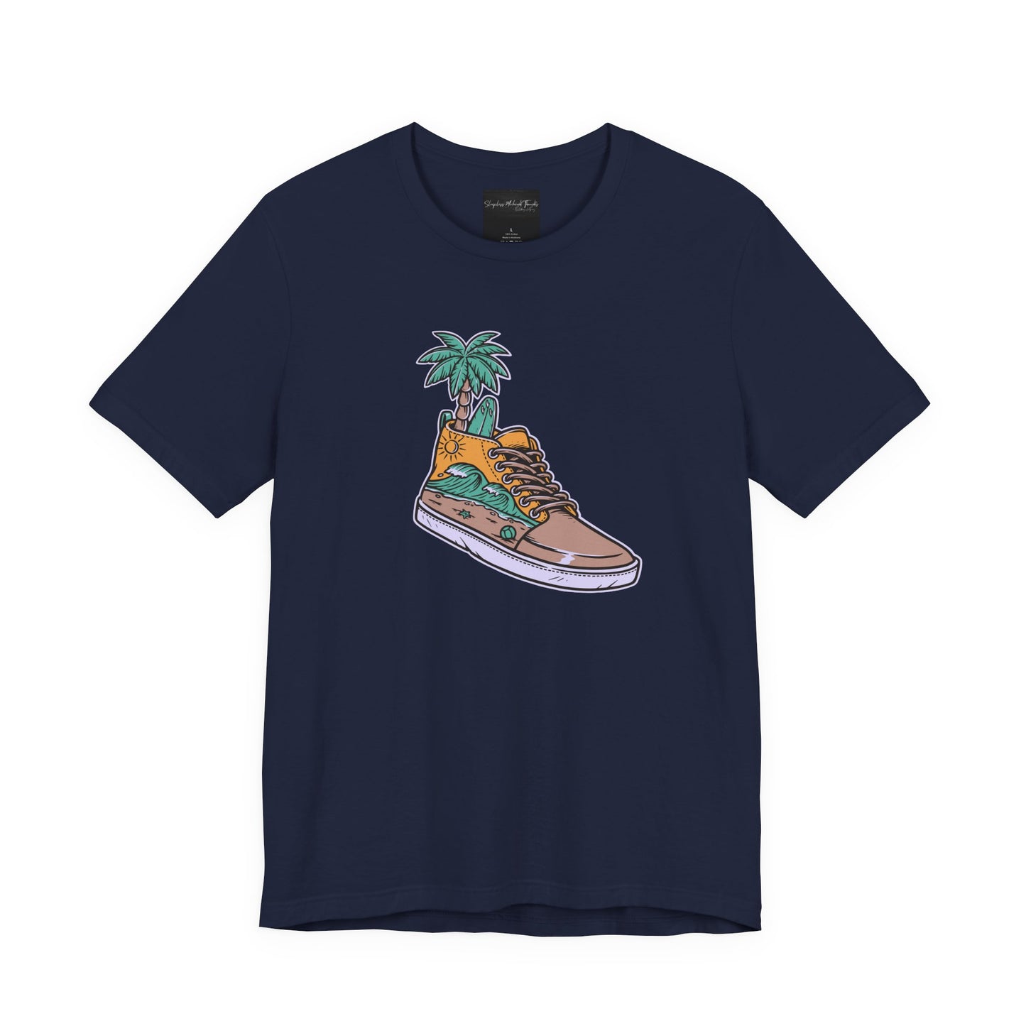On the front of this custom handmade short sleeve shirt is an image of a high top running shoe with ocean waves running along the side of the shoe, coming out of the top of the shoe where your foot goes is a palm tree and a surf board.