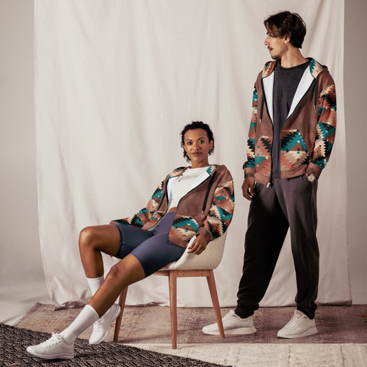 This custom unisex zip up hoodie has a western design to it with the front and the back of the hoodie being washed brown, each sleeve, the front pockets along with the inside of the hood have a brown, cream and turquoise Aztec pattern.