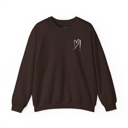 A handmade unisex oversized pullover sweatshirt with a crewneck, on the front left chest of the sweater in white is a heart with an exclamation point on the left hand side if the heart