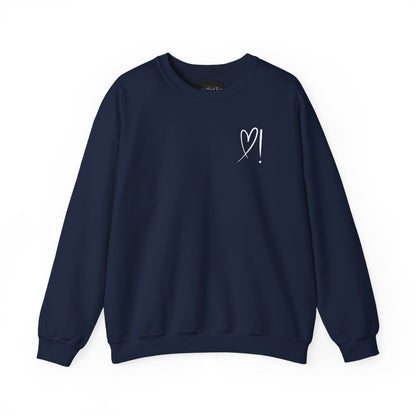 A handmade unisex oversized pullover sweatshirt with a crewneck, on the front left chest of the sweater in white is a heart with an exclamation point on the left hand side if the heart
