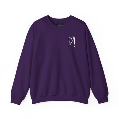 A handmade unisex oversized pullover sweatshirt with a crewneck, on the front left chest of the sweater in white is a heart with an exclamation point on the left hand side if the heart