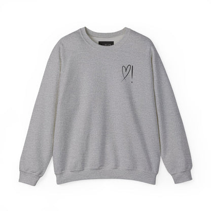 A handmade unisex oversized pullover sweatshirt with a crewneck, on the front left chest of the sweater in white is a heart with an exclamation point on the left hand side if the heart
