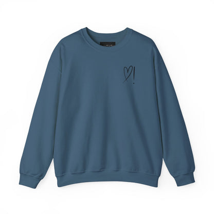A handmade unisex oversized pullover sweatshirt with a crewneck, on the front left chest of the sweater in white is a heart with an exclamation point on the left hand side if the heart