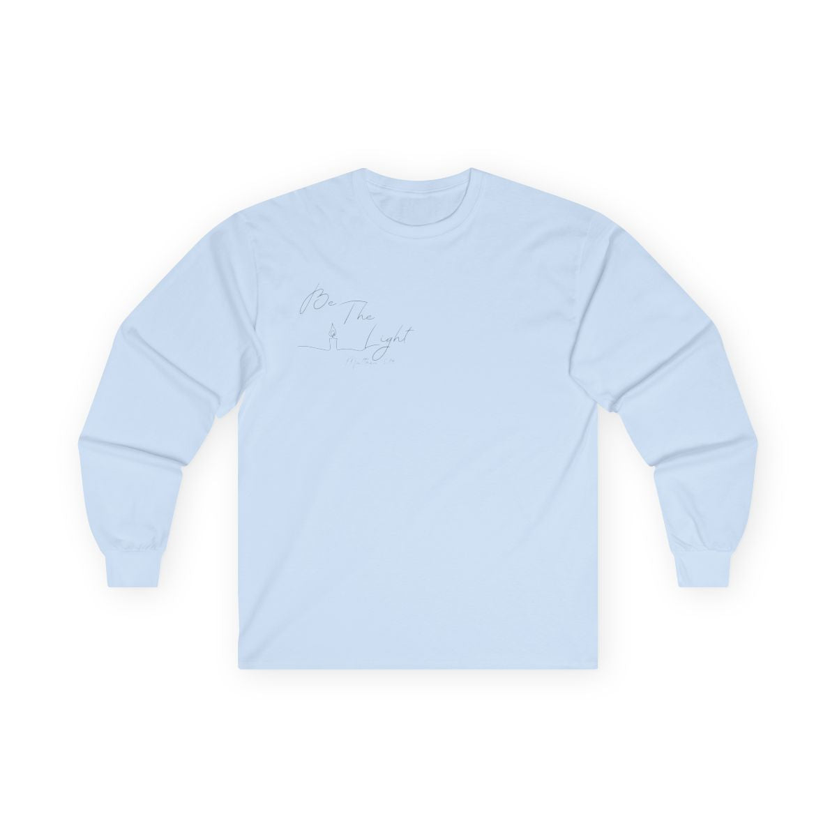 This Christian unisex Long Sleeve t-shirt features the words Be The Light Matthew 5:14 in a simple cursive font with an image of a line drawing of a candle next to the word light.