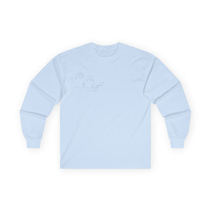 This Christian unisex Long Sleeve t-shirt features the words Be The Light Matthew 5:14 in a simple cursive font with an image of a line drawing of a candle next to the word light.