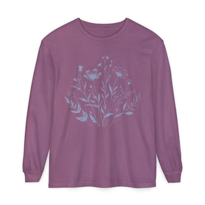 On the front of this custom women's long sleeve t-shirt is a image of a bunch of wildflowers and leaves coming from the bottom of the shirt to the very top, the flowers and leaves are in a light blue color.