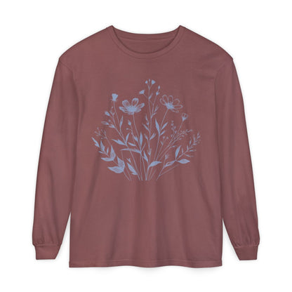 On the front of this custom women's long sleeve t-shirt is a image of a bunch of wildflowers and leaves coming from the bottom of the shirt to the very top, the flowers and leaves are in a light blue color.