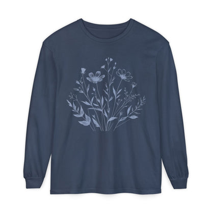 On the front of this custom women's long sleeve t-shirt is a image of a bunch of wildflowers and leaves coming from the bottom of the shirt to the very top, the flowers and leaves are in a light blue color.