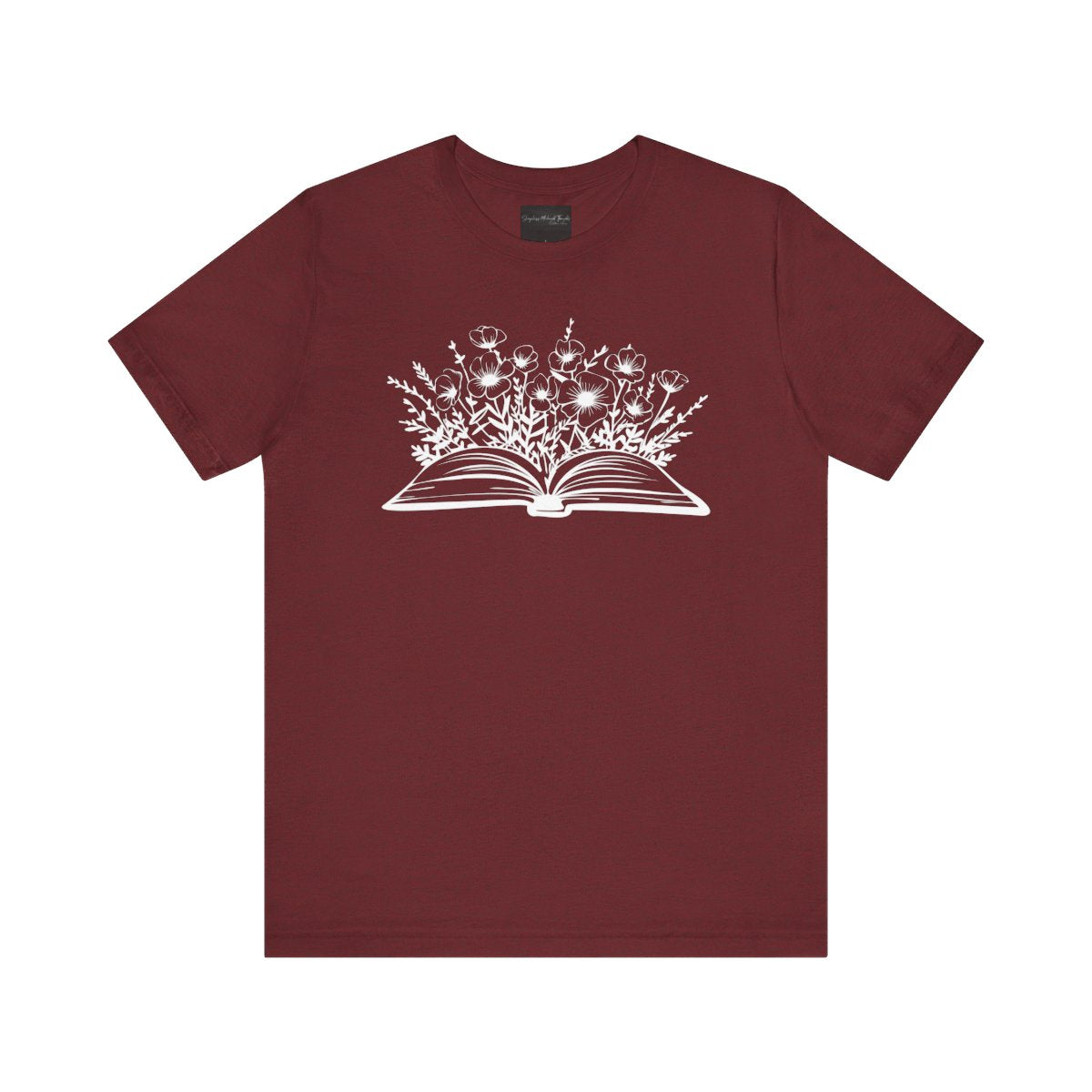 On the front of this custom women's book lover shirt is a image of a book with it opened in the middle, there are a bunch of wildflowers coming out of the center of the book.