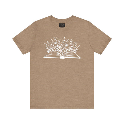 On the front of this custom women's book lover shirt is a image of a book with it opened in the middle, there are a bunch of wildflowers coming out of the center of the book.