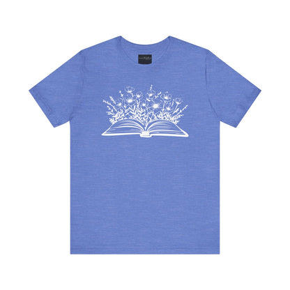On the front of this custom women's book lover shirt is a image of a book with it opened in the middle, there are a bunch of wildflowers coming out of the center of the book.
