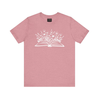 On the front of this custom women's book lover shirt is a image of a book with it opened in the middle, there are a bunch of wildflowers coming out of the center of the book.
