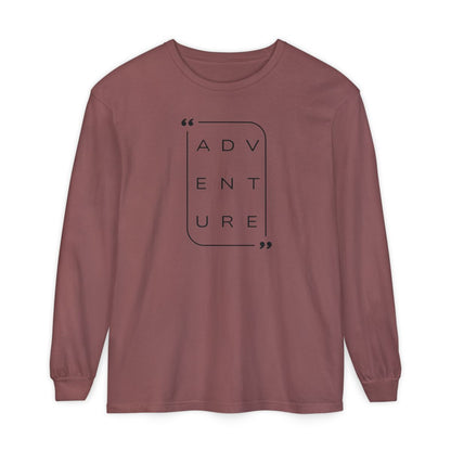 On the front of this super soft unisex long sleeve shirt is the word adventure with there being three letters on each line, it is in a modern font. There is a border around the word.