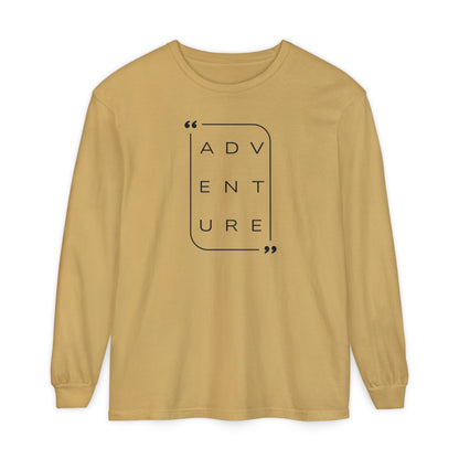 On the front of this super soft unisex long sleeve shirt is the word adventure with there being three letters on each line, it is in a modern font. There is a border around the word.