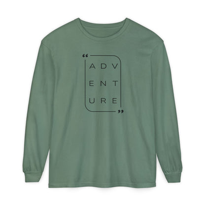 On the front of this super soft unisex long sleeve shirt is the word adventure with there being three letters on each line, it is in a modern font. There is a border around the word.