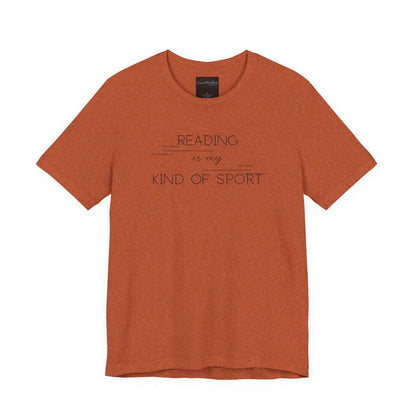 On the front of this custom booklover short sleeve shirt are the words Reading is my Kind of Sport, in a modern font with different length lines on either end of the writing giving the shirt a retro look.