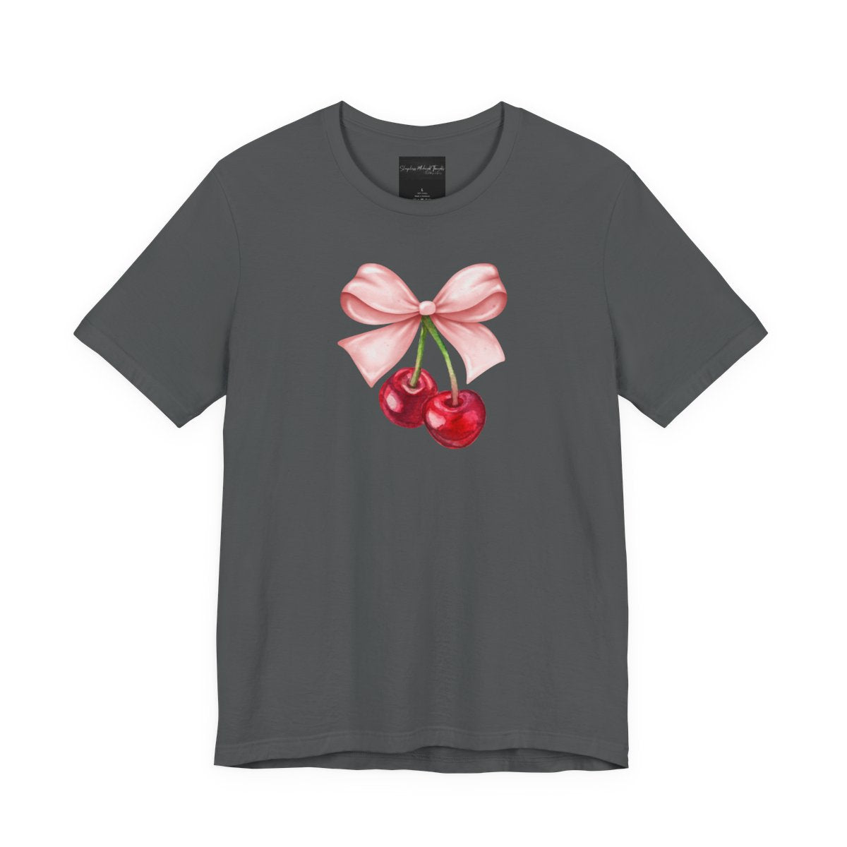 On the front of this custom women's short sleeve shirt is an image of a pair of cherries hanging from a stem with a pink bow on the top of them.