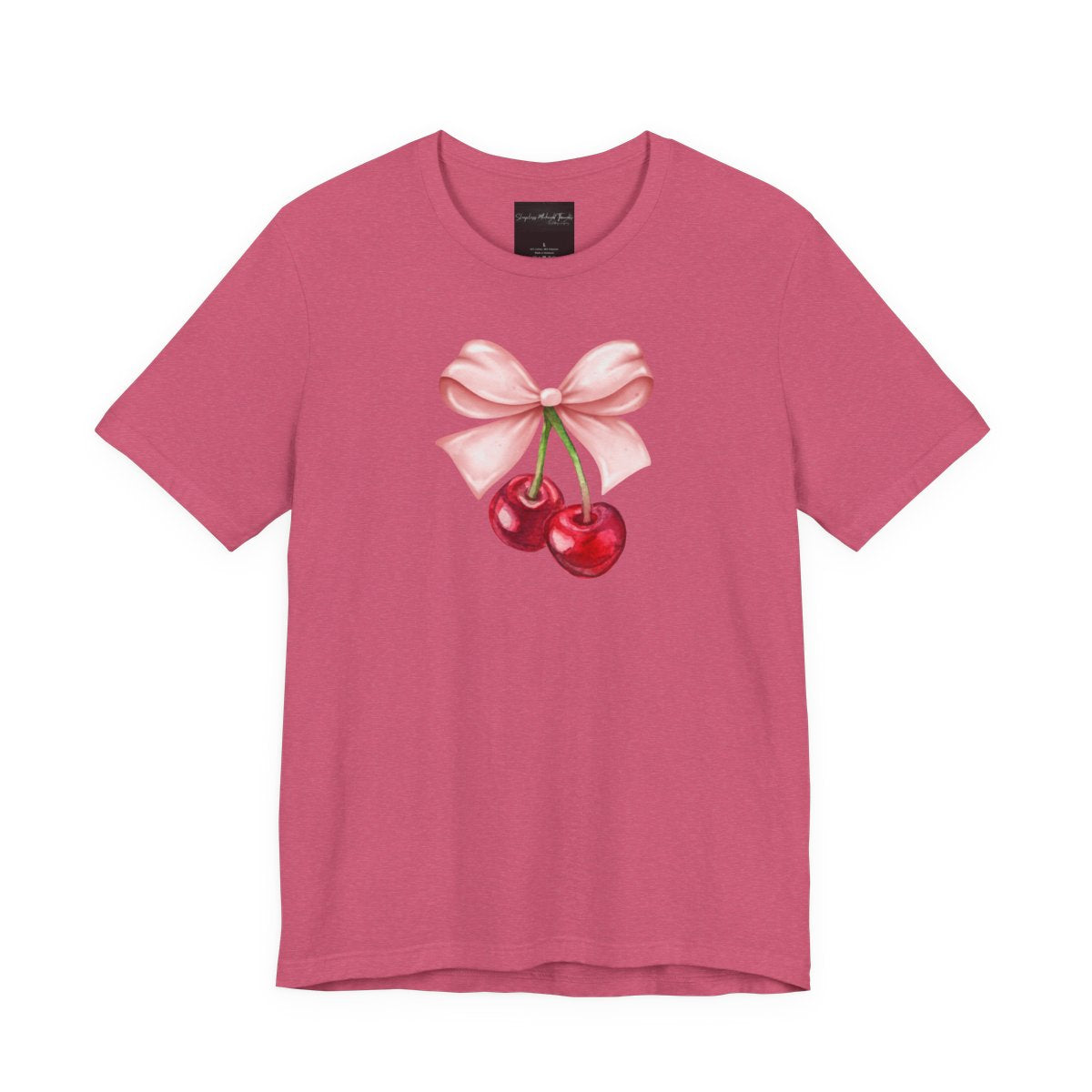 On the front of this custom women's short sleeve shirt is an image of a pair of cherries hanging from a stem with a pink bow on the top of them.
