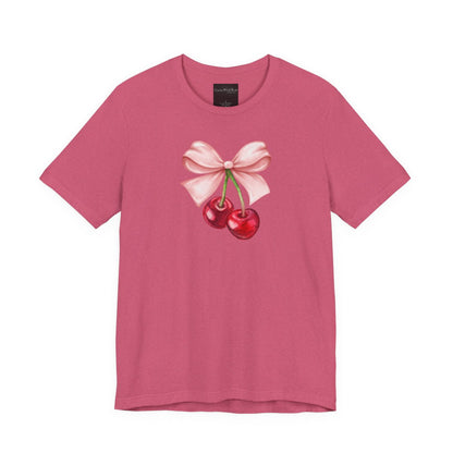 On the front of this custom women's short sleeve shirt is an image of a pair of cherries hanging from a stem with a pink bow on the top of them.