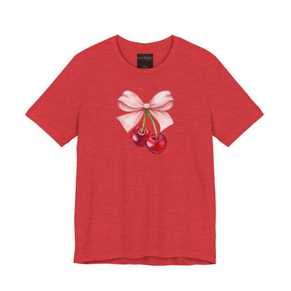 On the front of this custom women's short sleeve shirt is an image of a pair of cherries hanging from a stem with a pink bow on the top of them.