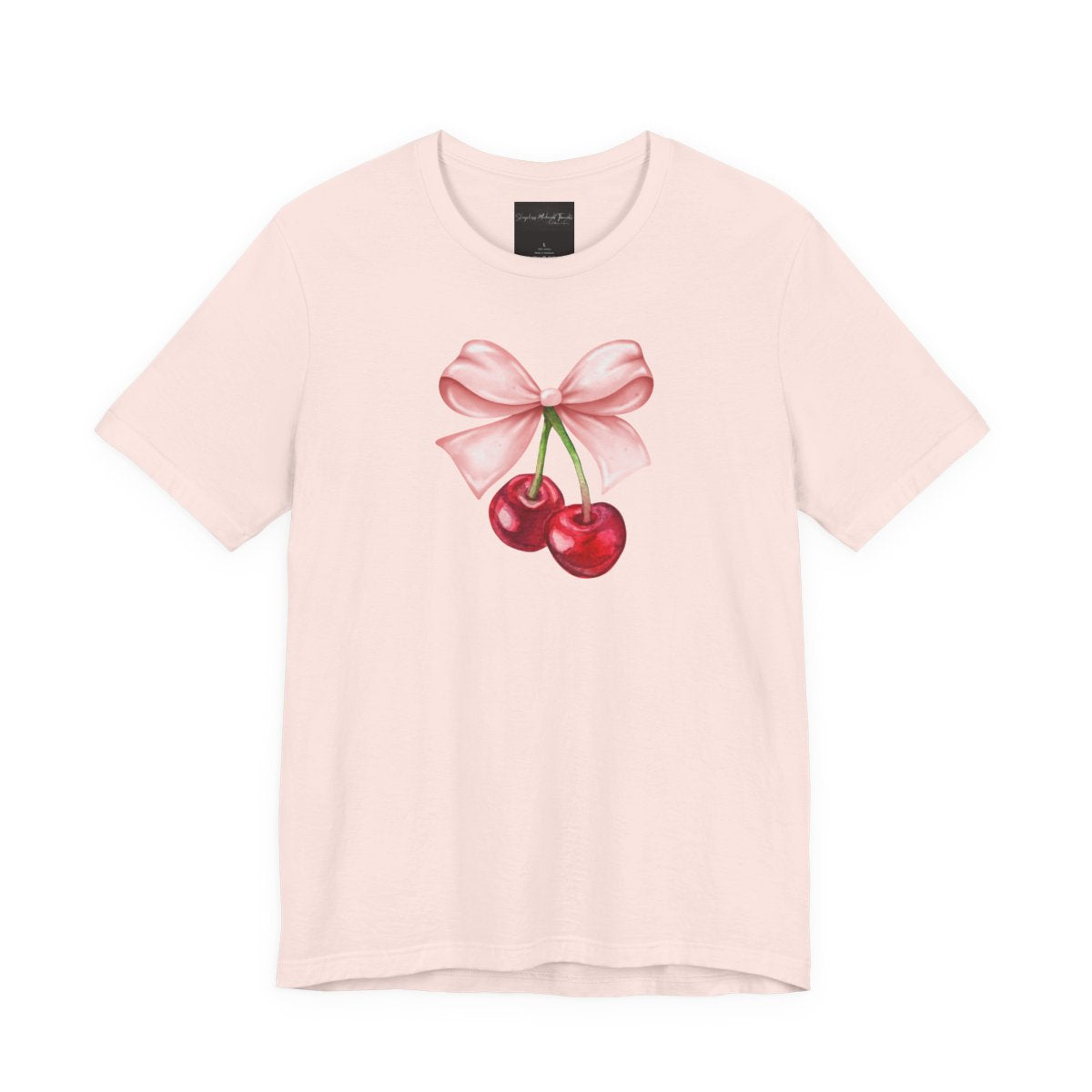On the front of this custom women's short sleeve shirt is an image of a pair of cherries hanging from a stem with a pink bow on the top of them.