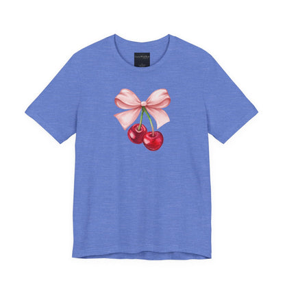 On the front of this custom women's short sleeve shirt is an image of a pair of cherries hanging from a stem with a pink bow on the top of them.