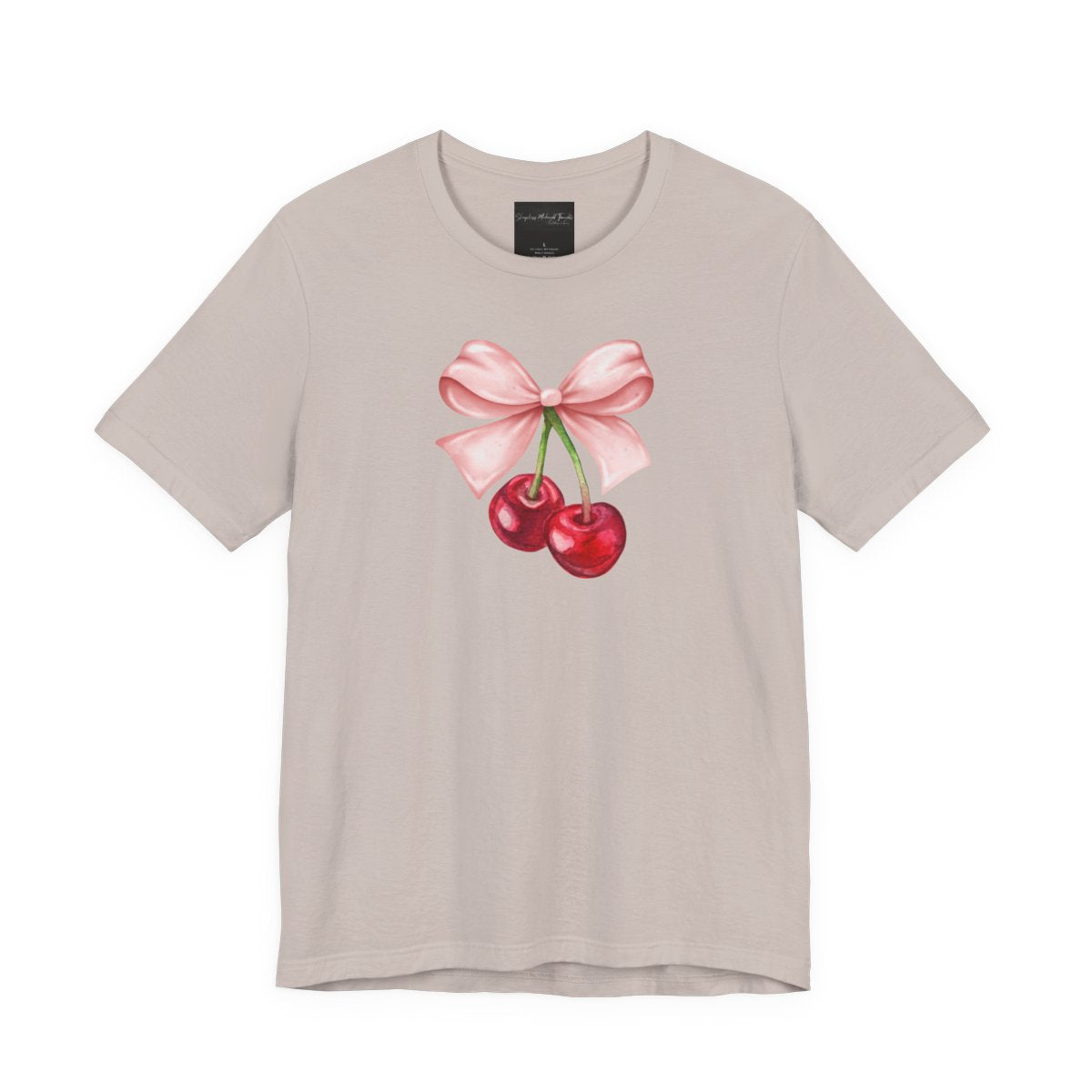 On the front of this custom women's short sleeve shirt is an image of a pair of cherries hanging from a stem with a pink bow on the top of them.