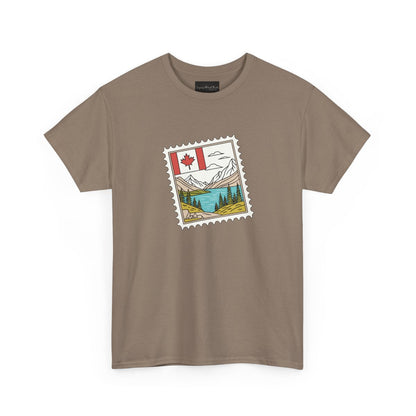 On the front of this custom Canadian pride short sleeve shirt is an image of a Canadian postage stamp with the Canadian flag in one corner and an image of mountains, a lake, and trees the make up the rest of the stamp.