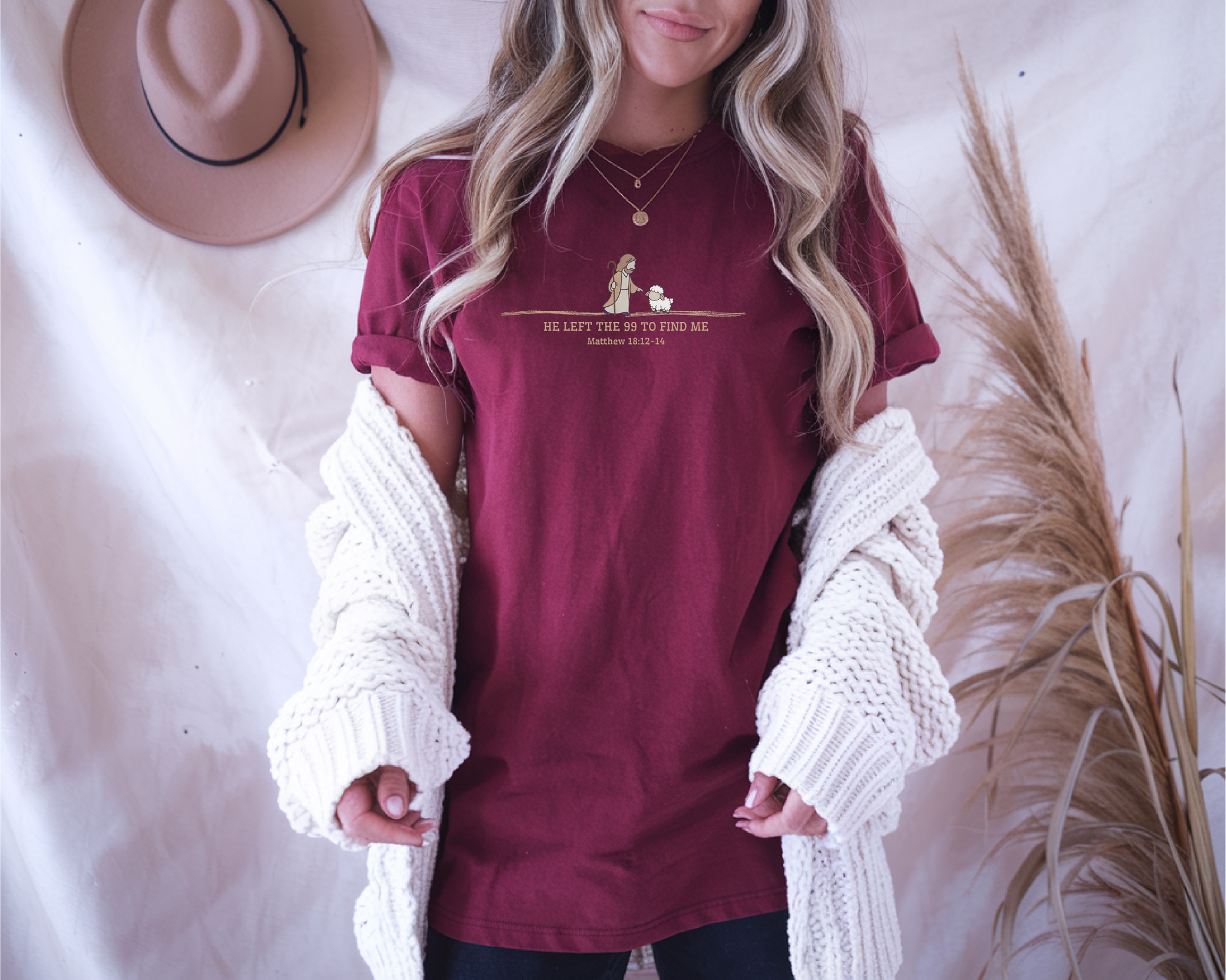 On the front of this custom Christian t-shirt is an image of Jesus the shepherd standing next to a little lamb, underneath the image are the words He left the 99 to Rescue Me Matthew 18:12-14.