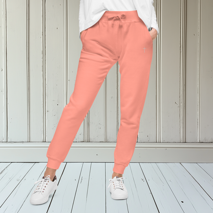 A pair of super soft ankle length Christian unisex sweatpants, there are two pockets on the front and one pocket on the back right, on the front left pocket is a embroidered white cross.