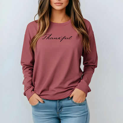 On the front of this custom unisex long sleeve t-shirt is the word thankful in a flowy cursive font.