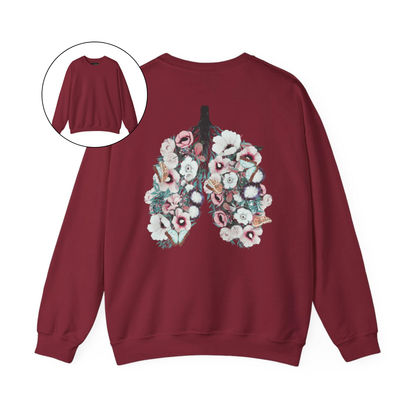 On the back of this women's pullover sweatshirt is an image of a set of lungs, but the lungs are made out of vines with pink and white flowers all over them, there are butterflies sitting in top of the flowers that are light blue in color.