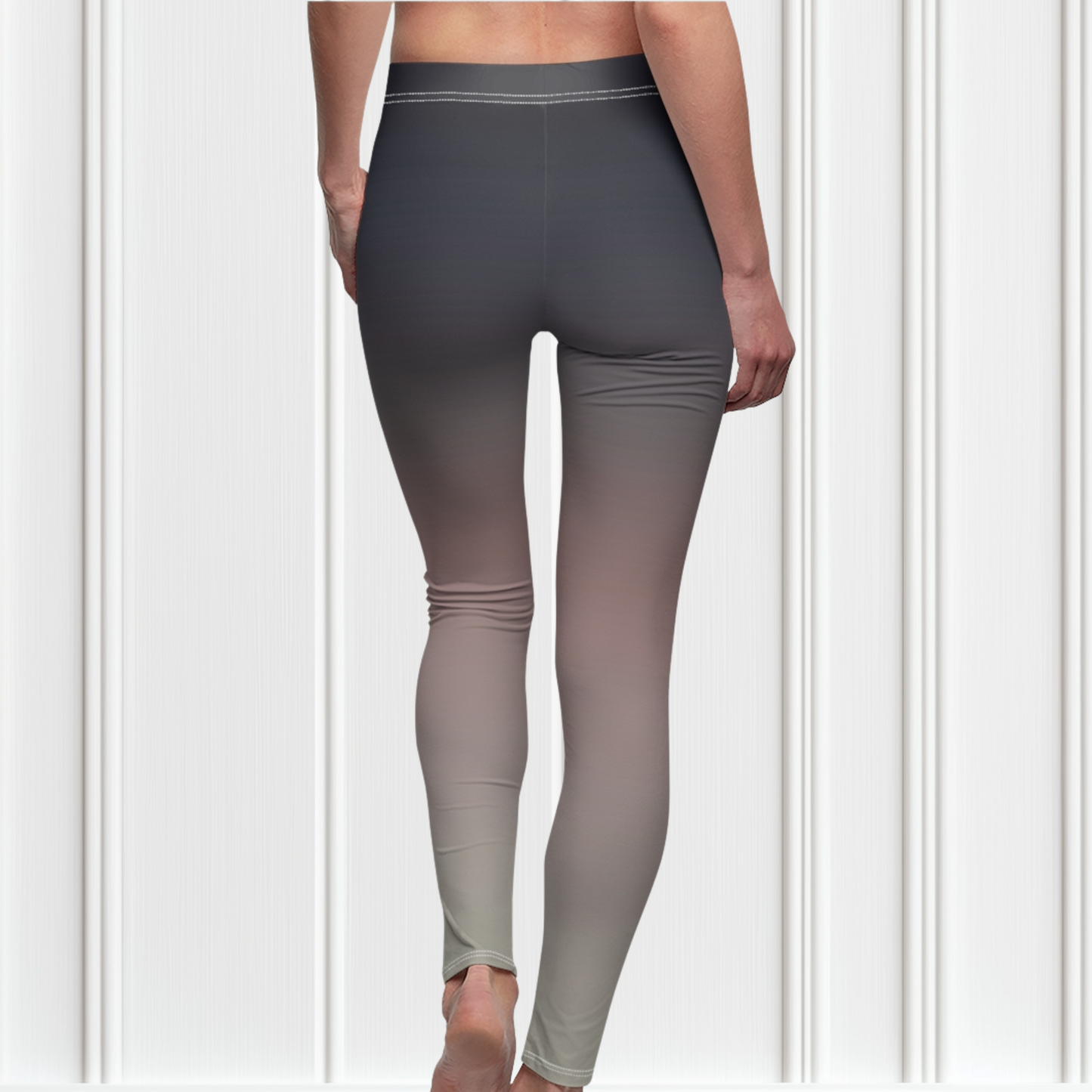 A pair of women's custom high waisted leggings that have an ombre pattern that starts as black at the top of the leggings then fades to a light pink in the middle then to a beige at the bottom of the pants.