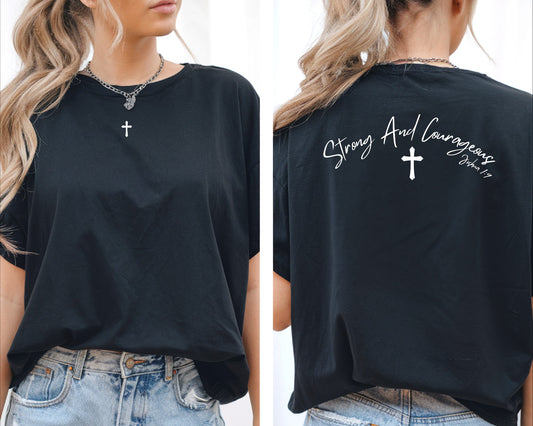 On the front center of this Christian shirt is a small Jesus cross, on the back of the is short sleeve tee is the scripture Strong and Courageous Joshua 1:9