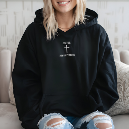 On the front of this custom embroidered unisex hooded sweatshirt are the words Jesus King of Kings with a Jesus cross in the center embroidered into the upper middle of the hoodie in silver thread.